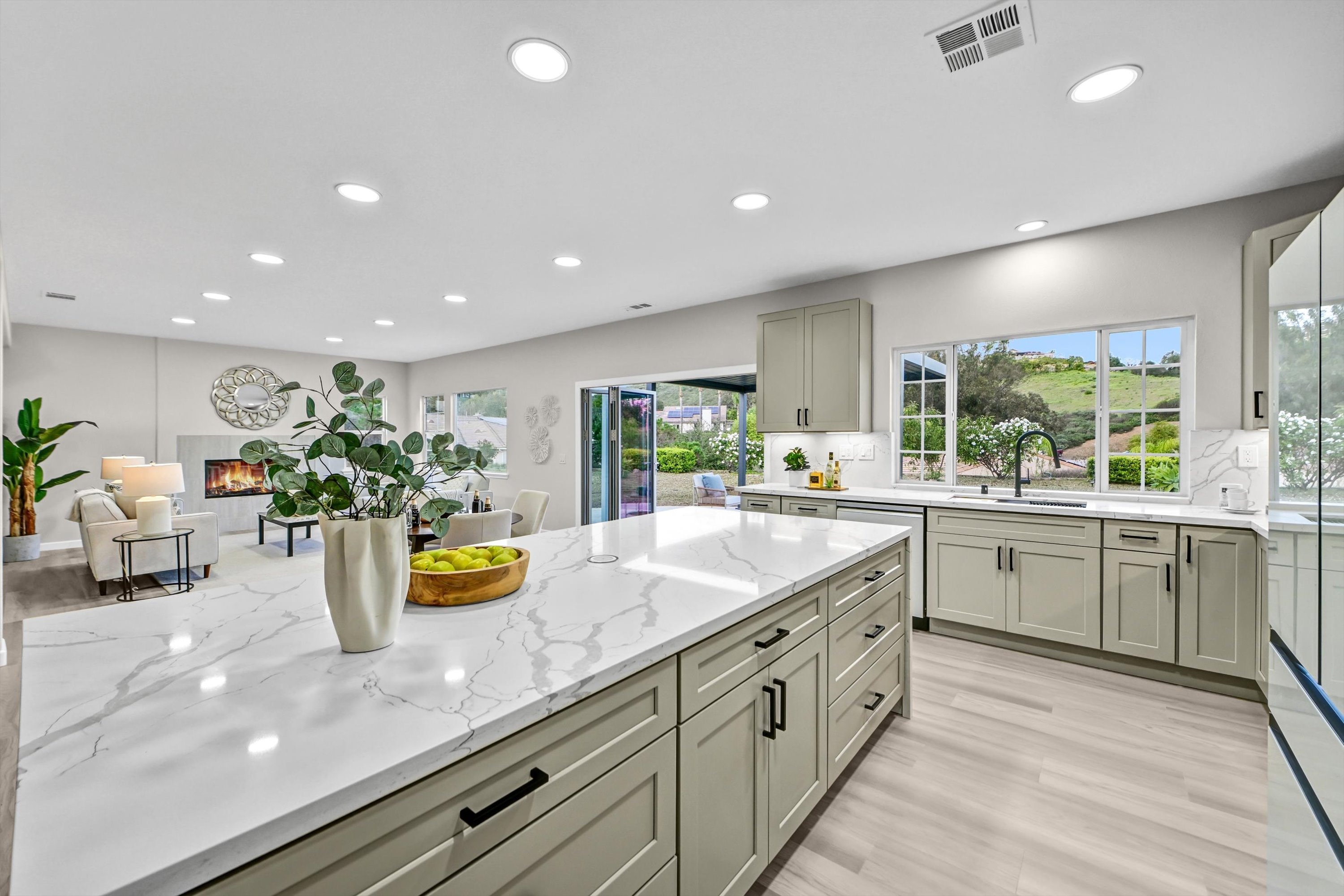 Completed ADU kitchen with marble countertops and custom cabinetry