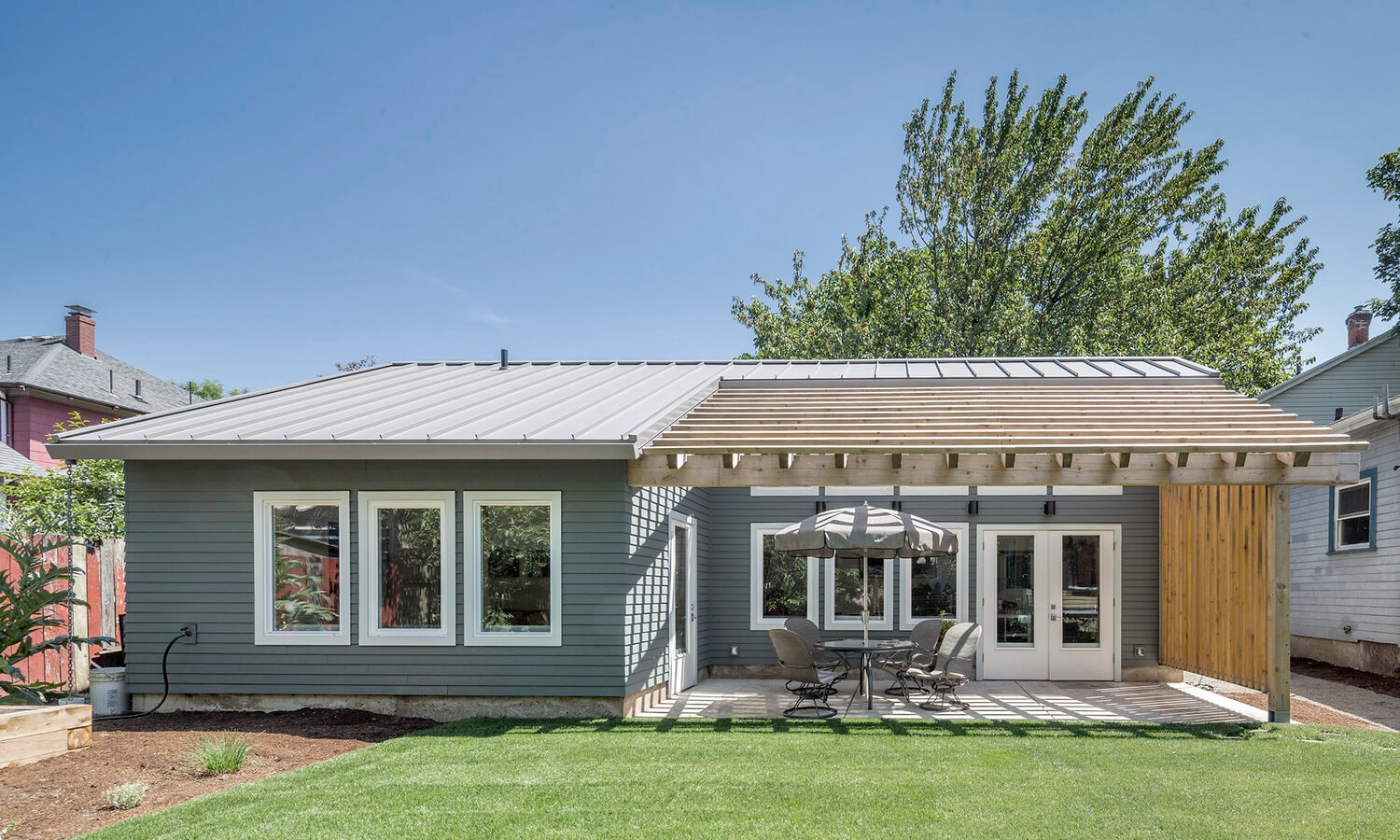 Modern ADU exterior with metal roof and covered patio